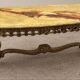 Large oval coffee table in yellow marble and gold metal, classic style.