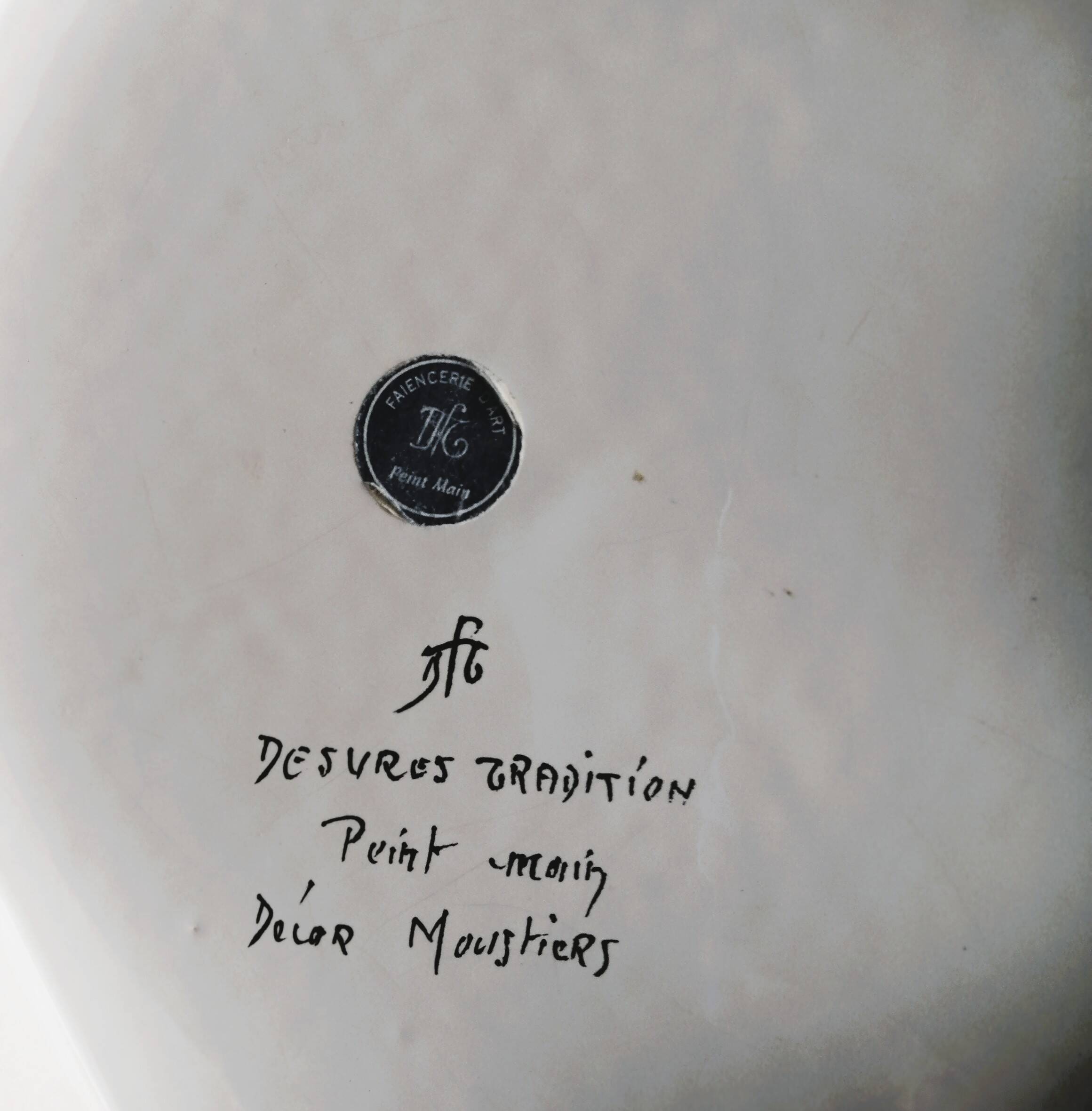 Hand-painted flat dish decorated in the Moustier style.