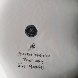 Hand-painted flat dish decorated in the Moustier style.