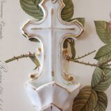 Antique holy water font in white porcelain biscuit.