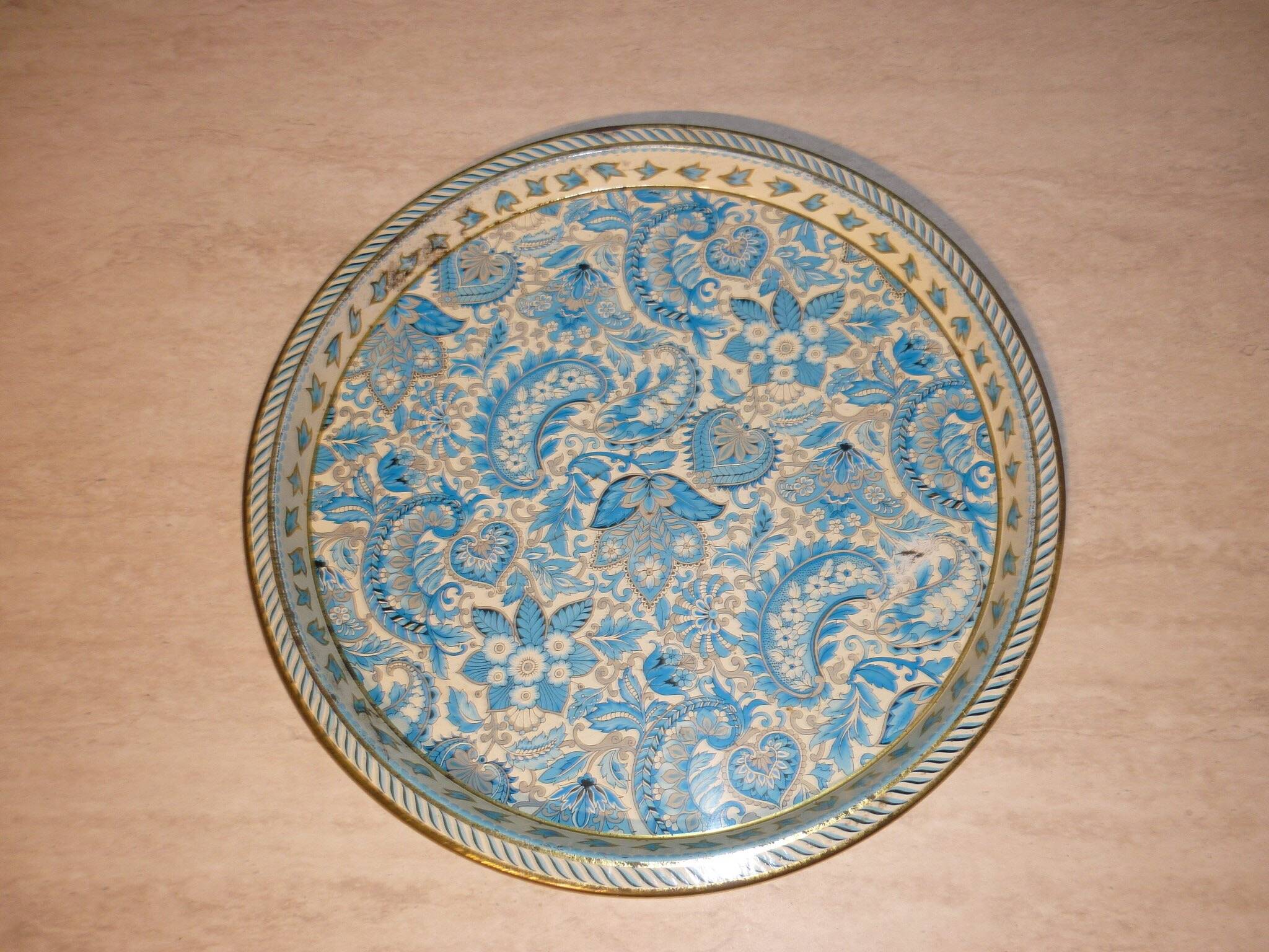 Blue cashmere round tray on white background.