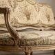 Louis XV style canapé in carved natural wood and floral upholstery.