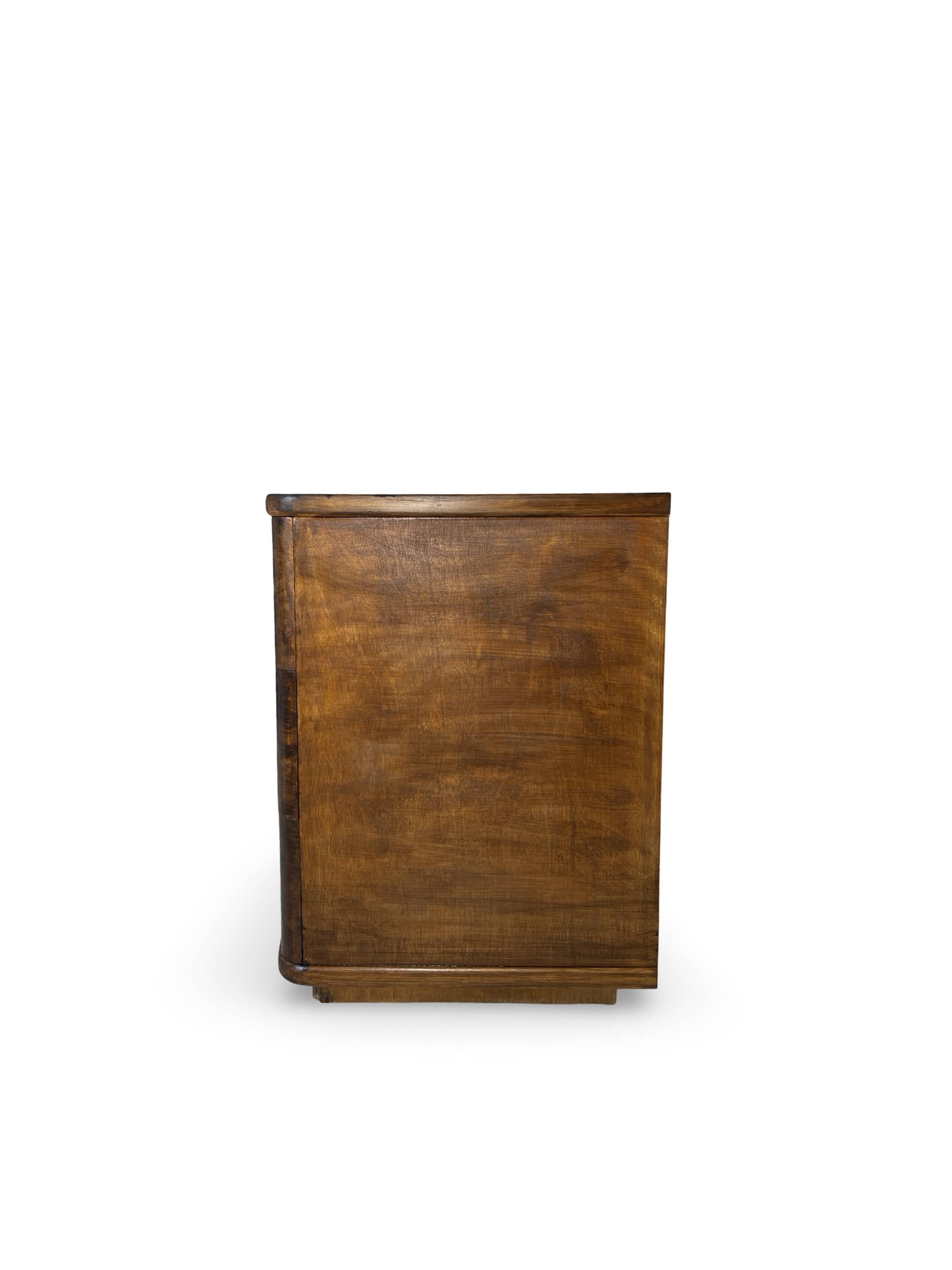A vintage Italian chest of drawers, made of veneered walnut and solid wood,