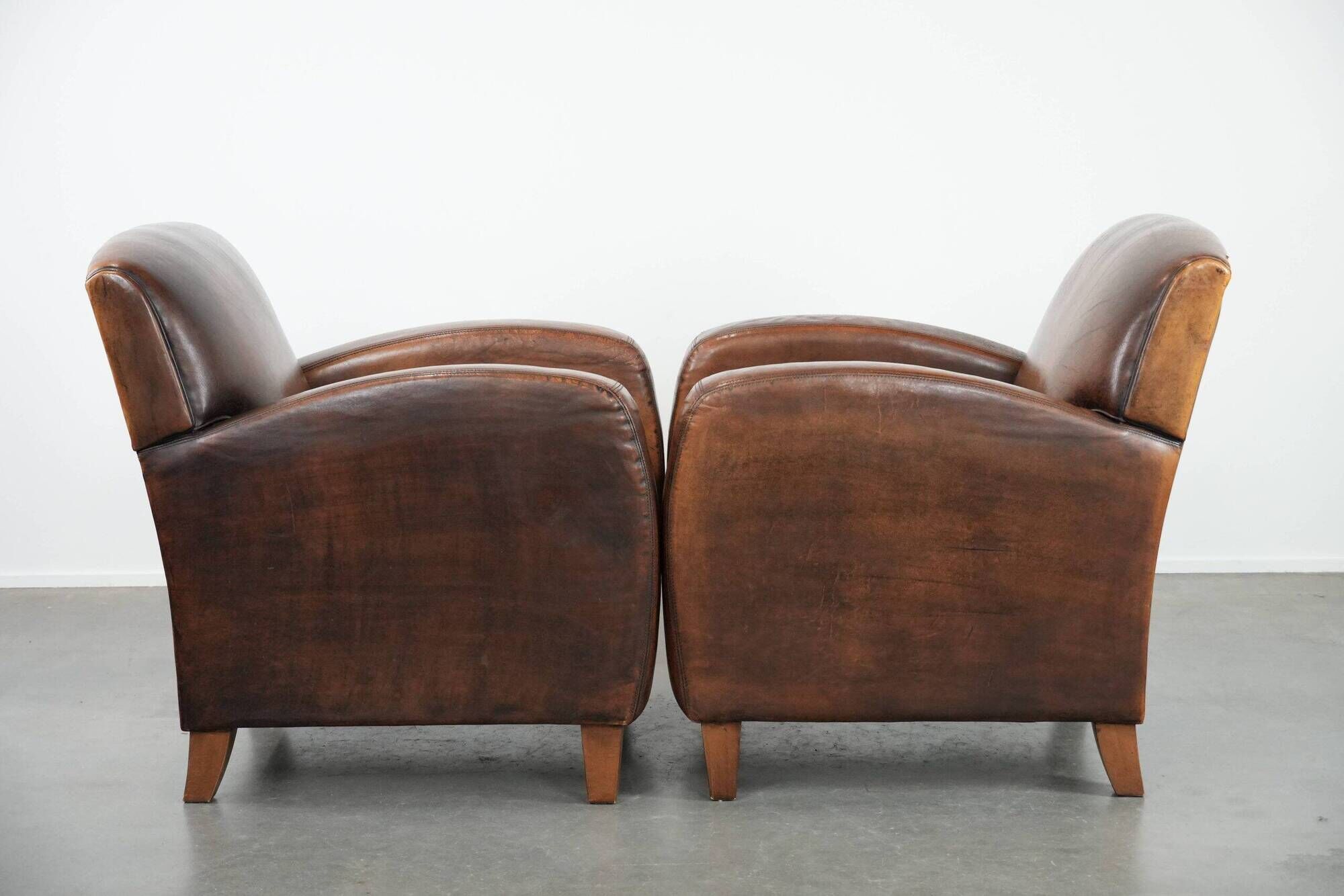Characterful set of two vintage sheepskin armchairs with beautiful colours