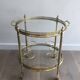 Round brass rolling table attributed to Maison Jansen