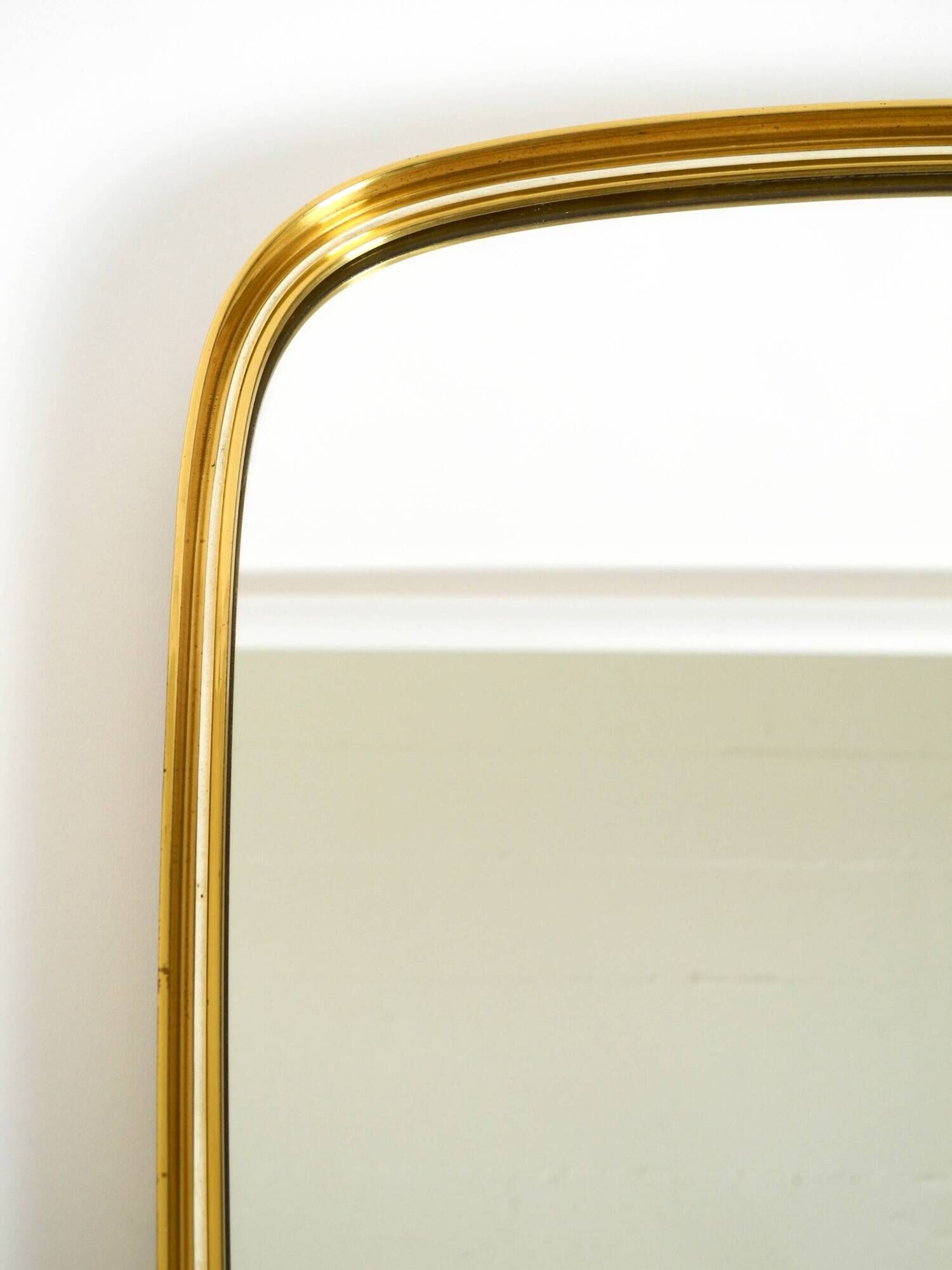 A pair of rare Mid Century "Münchener Zierspiegel" brass wall mirrors