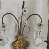 Pair of French antique brass double wall lights with assorted crystals.