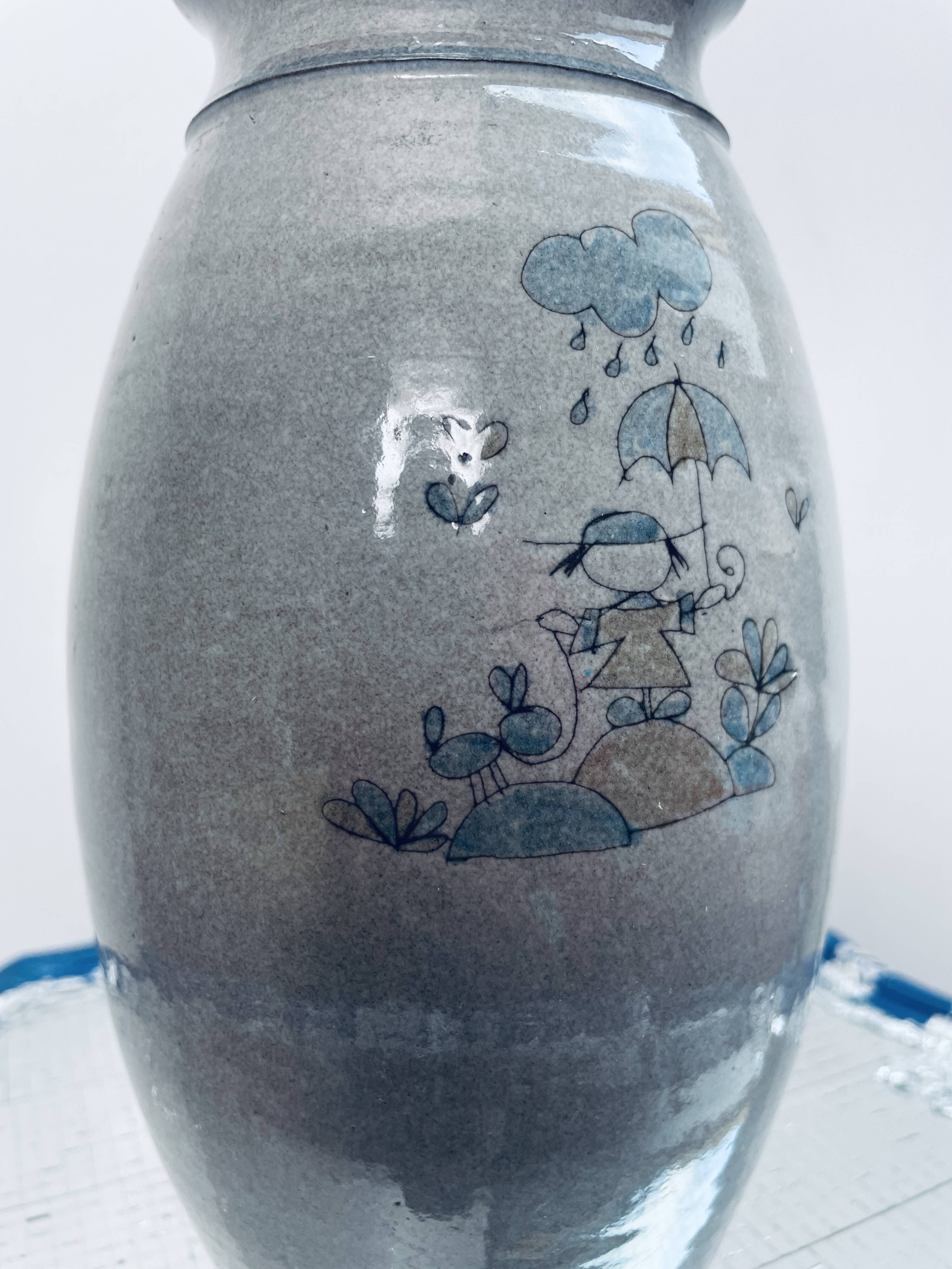 Handcrafted gray stoneware vase with child illustration