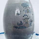 Handcrafted gray stoneware vase with child illustration