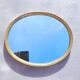 Oval mirror in gold metal