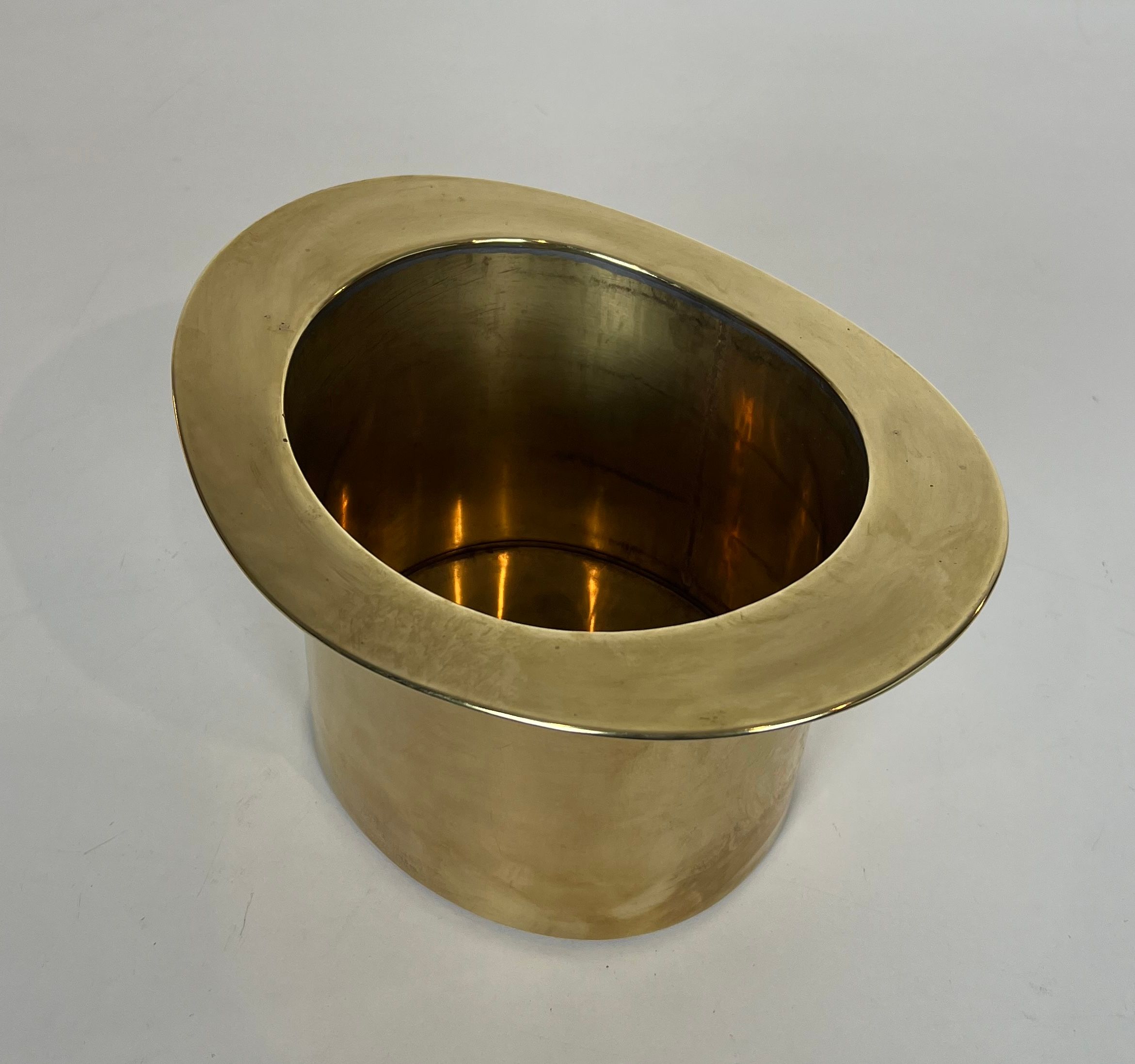 Champagne cooler shaped like a brass top hat.