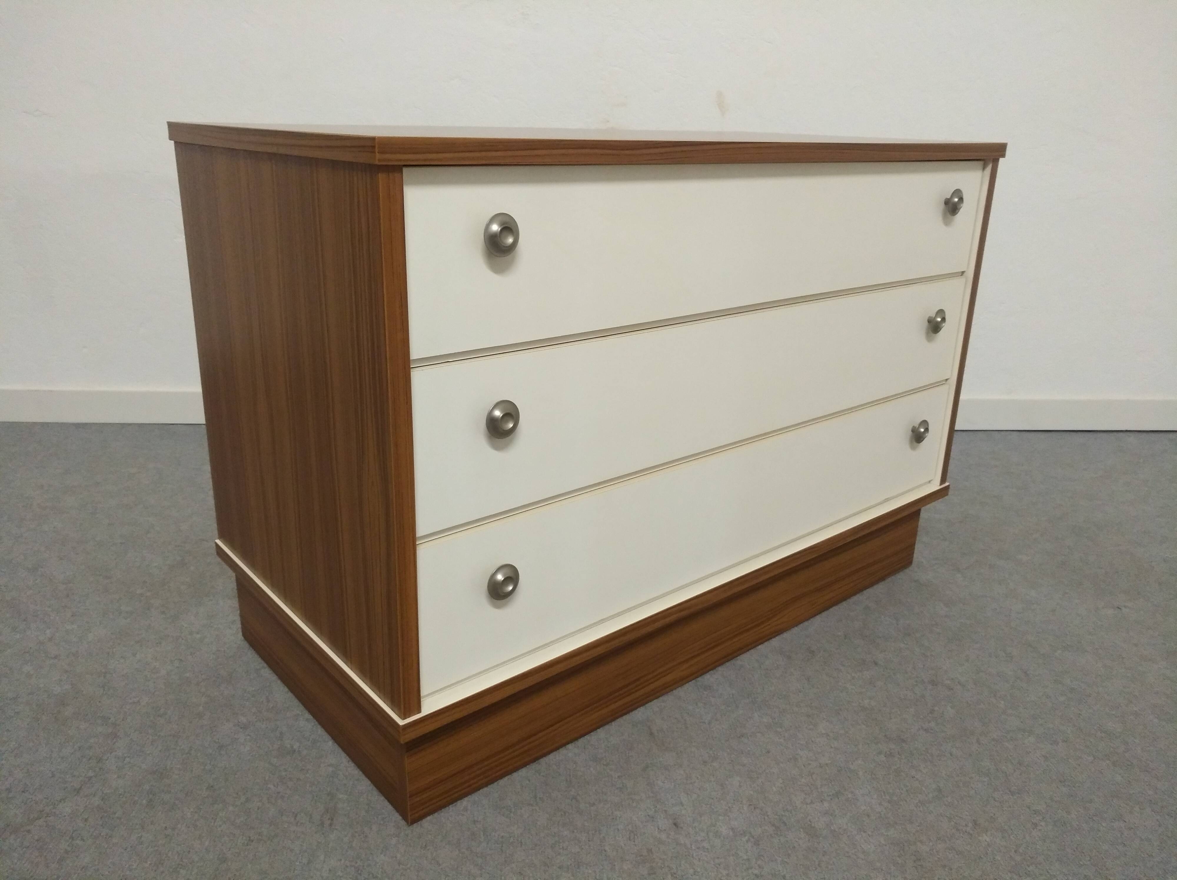 Low chest of drawers with 3 drawers in mahogany and white satin, France circa 1980.