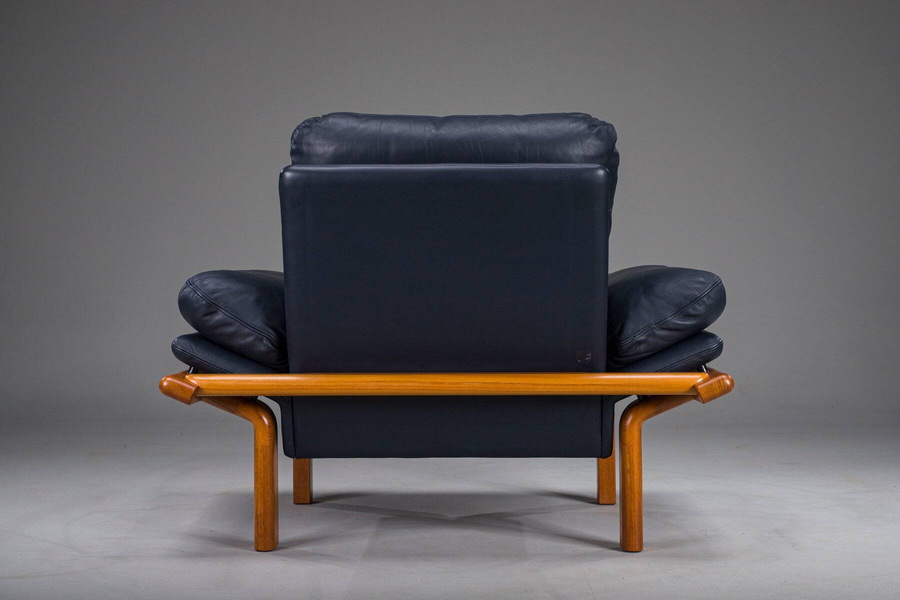 Danish teak and navy blue leather lounge chair from Komfort, 1970s