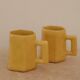 Set of two designer lemon yellow ceramic mugs
