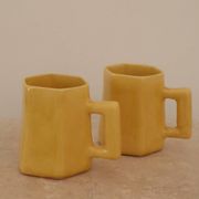 Set of two designer lemon yellow ceramic mugs