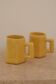 Set of two designer lemon yellow ceramic mugs
