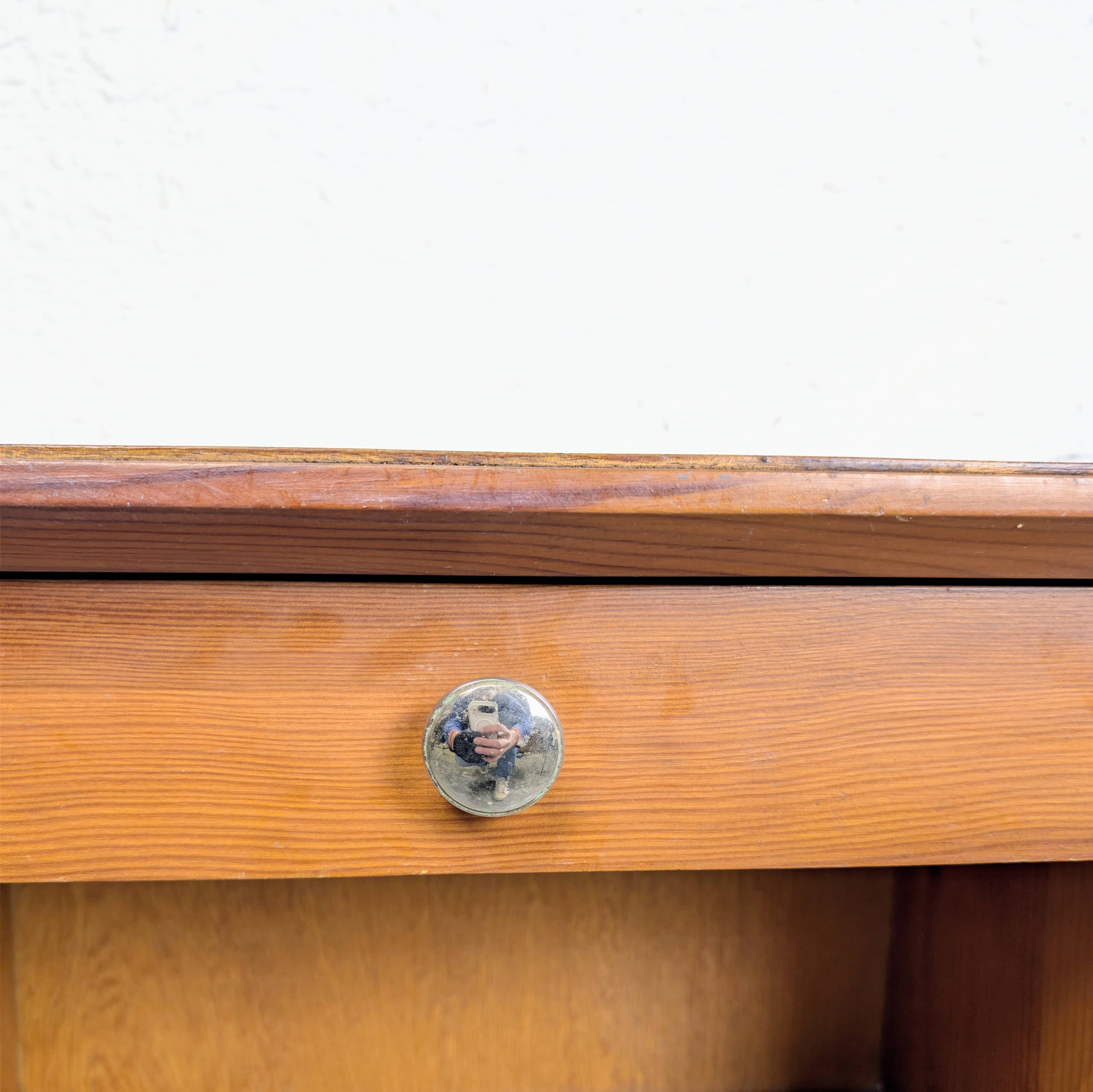 Vintage bedside table with tapered legs.