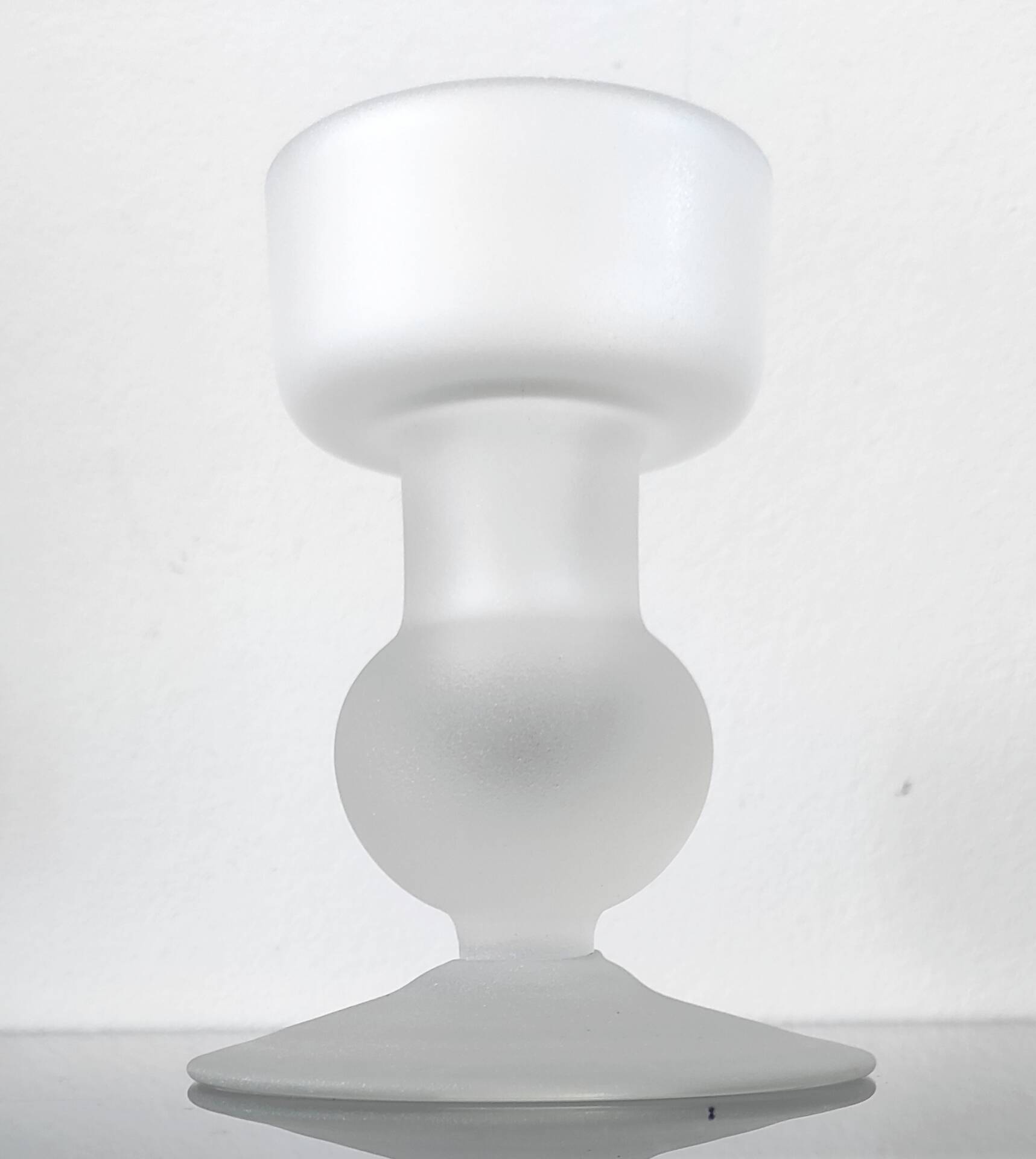 Sculptural candle holder in frosted glass.