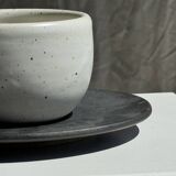 White Indonesian ceramic cup and gray saucer