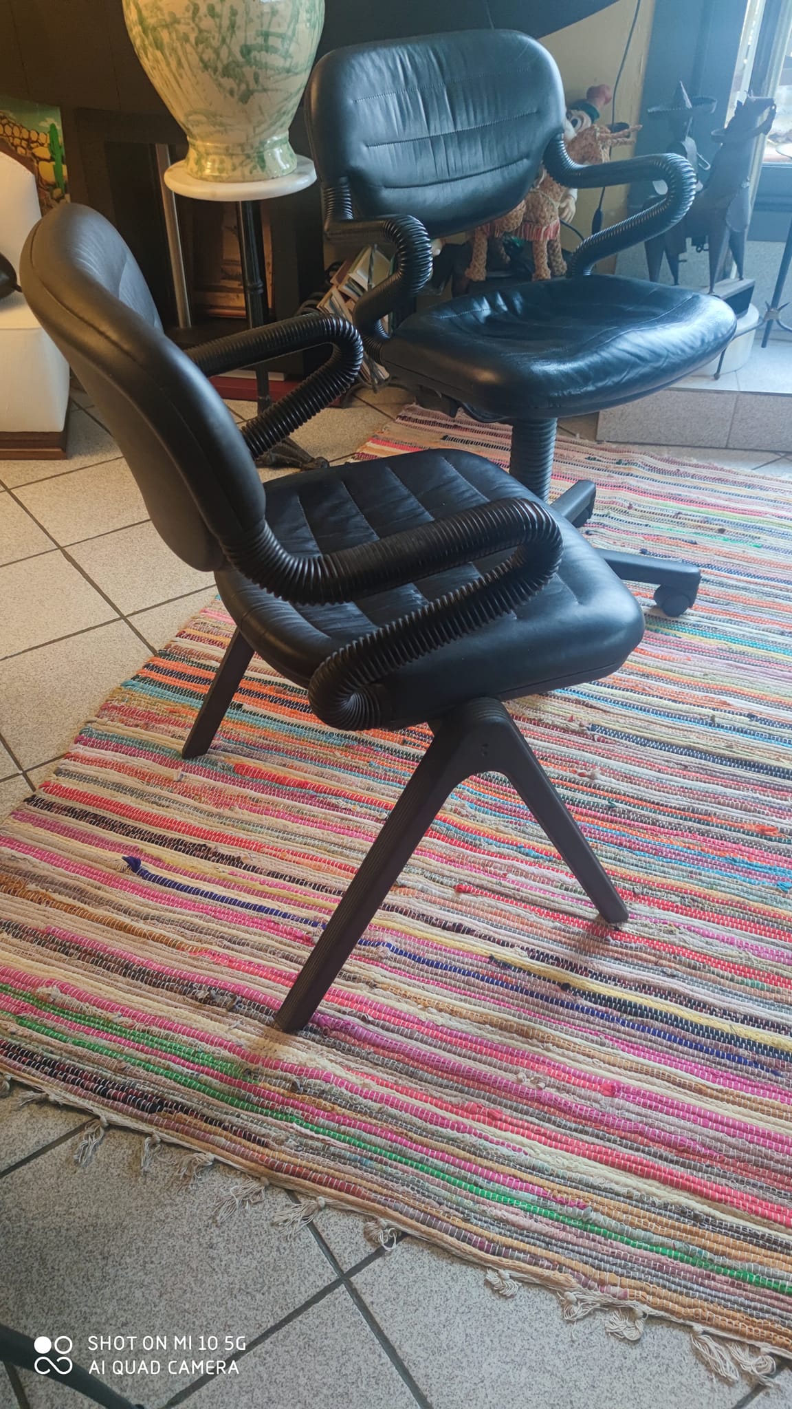Two black leather armchairs