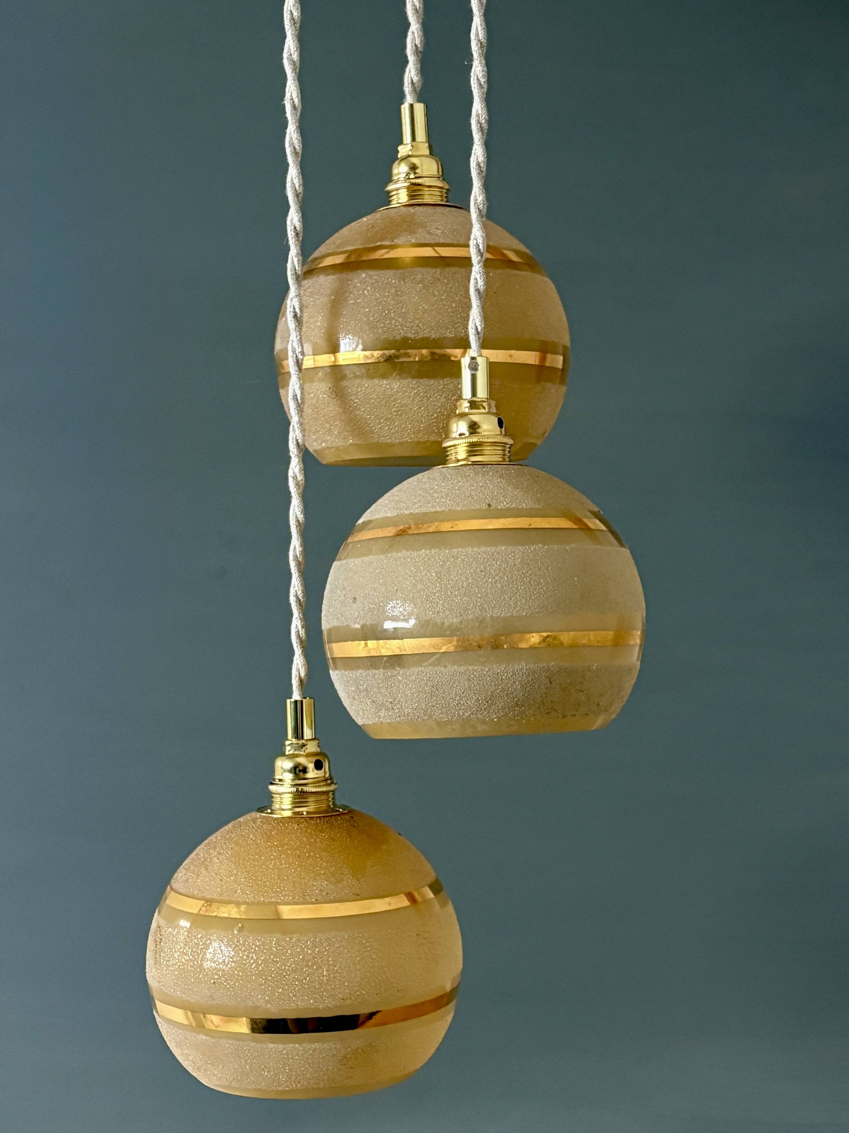 Suspension triple vintage glass globes in frosted yellow and gold.