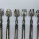 Set of 6 silver-plated oyster forks with 7 knot pattern filigree.