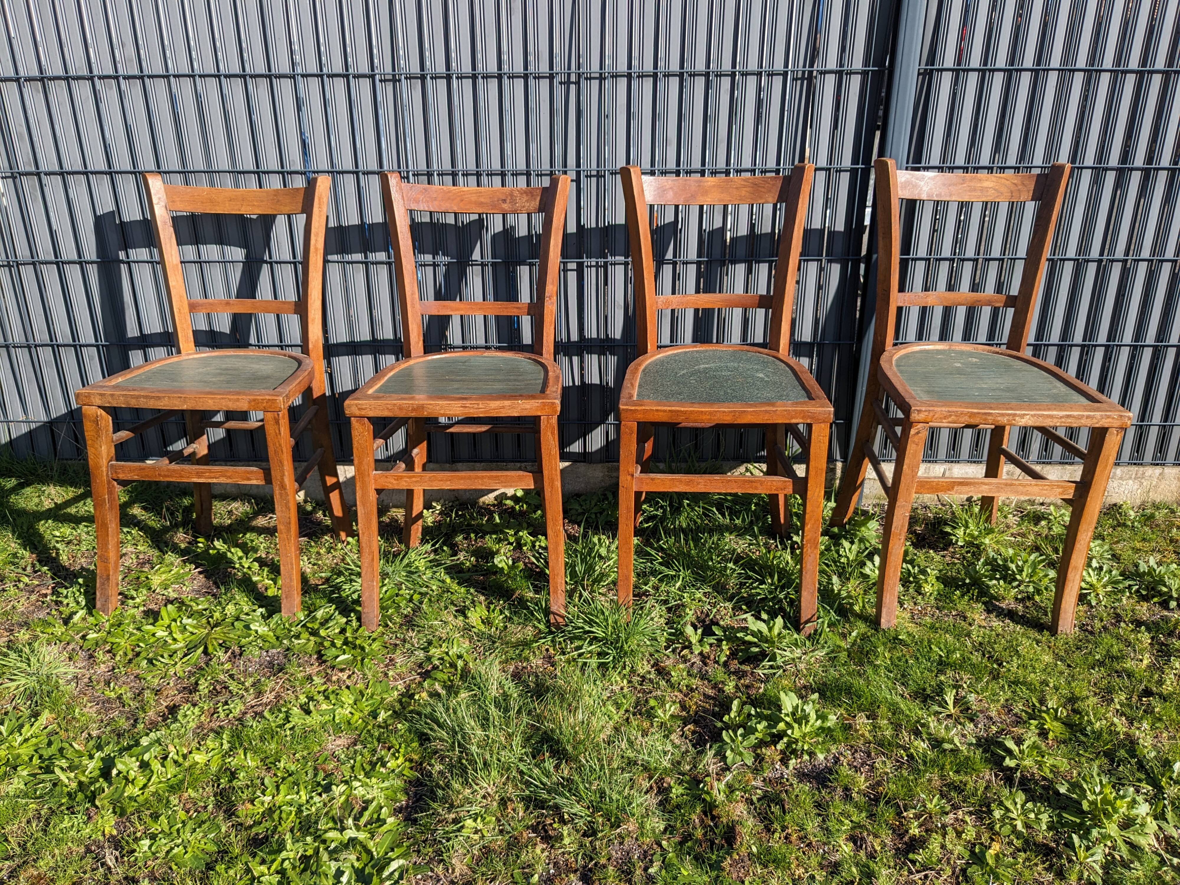 Set of four wooden bistro chairs, green seat, mid-20th century.