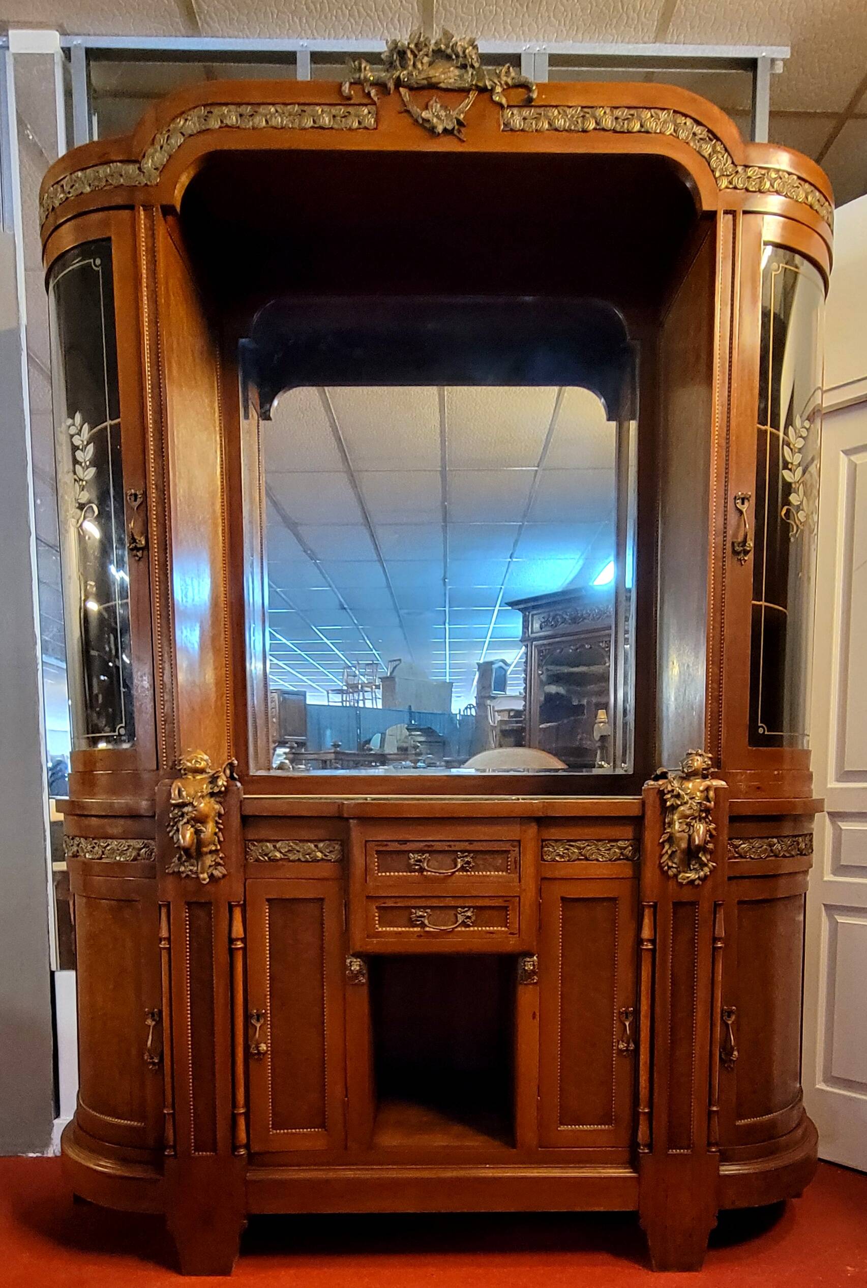 Empire style half-moon shaped mahogany bookcase with putti