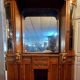 Empire style half-moon shaped mahogany bookcase with putti