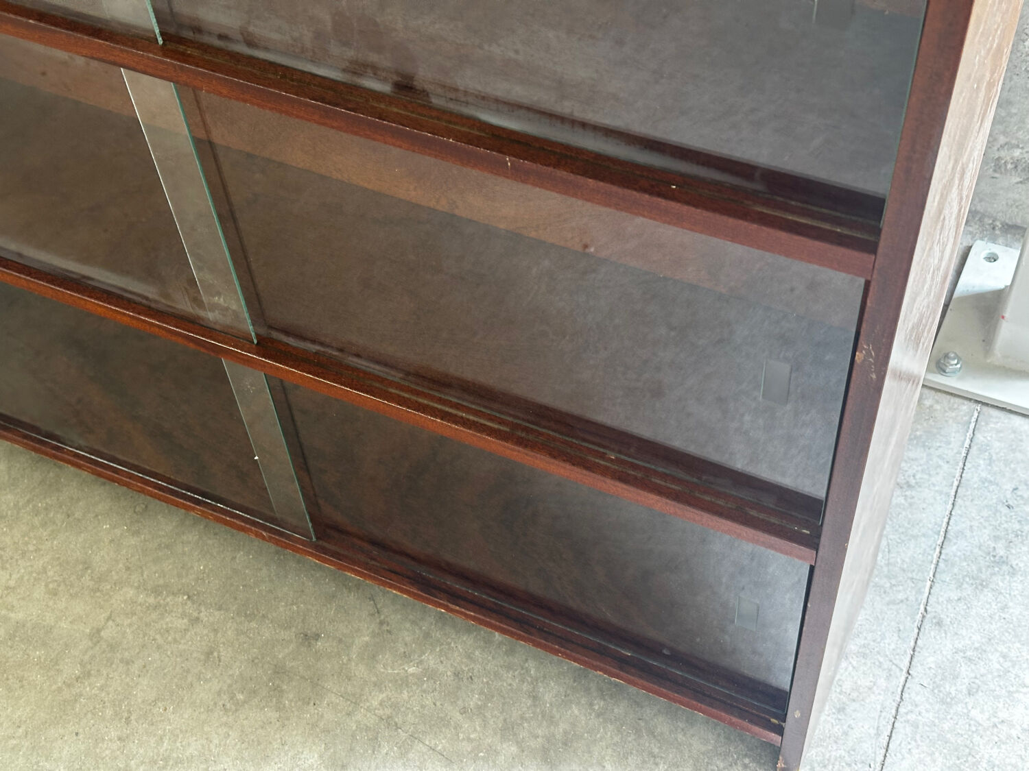 Vintage 1960s wooden library with sliding doors.