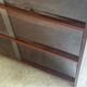 Vintage 1960s wooden library with sliding doors.