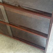 Vintage 1960s wooden library with sliding doors.