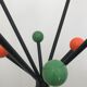 Wearing chrome parrot coat, black and multicolored balls