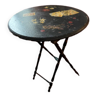 Folding pedestal table with decorated top