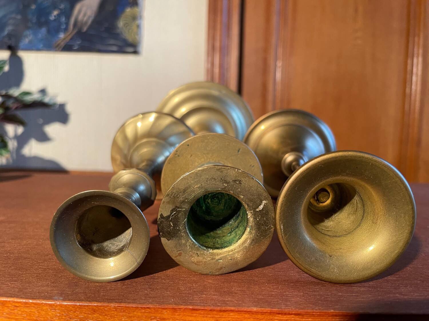 Trio of brass candlesticks