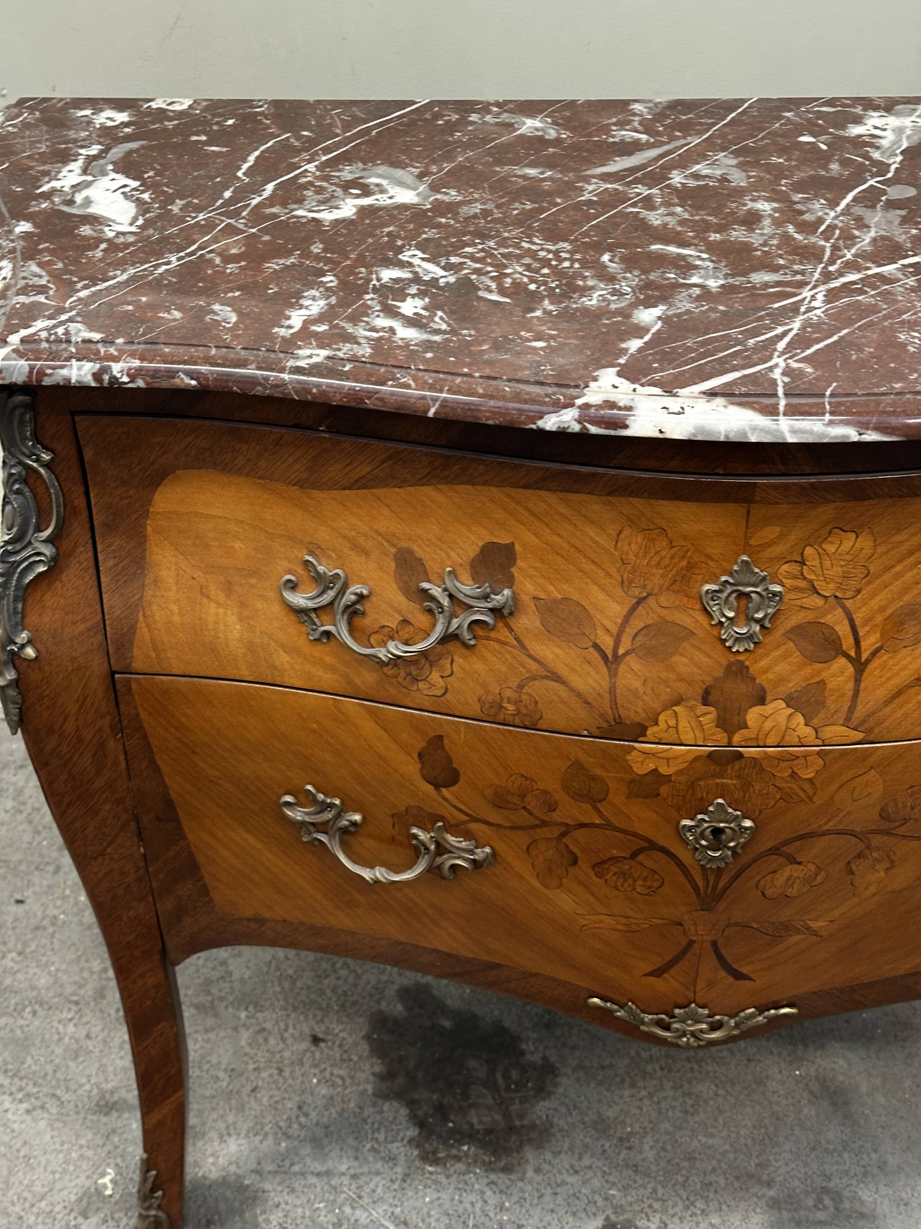 Curved and inlaid Louis XV style chest of drawers