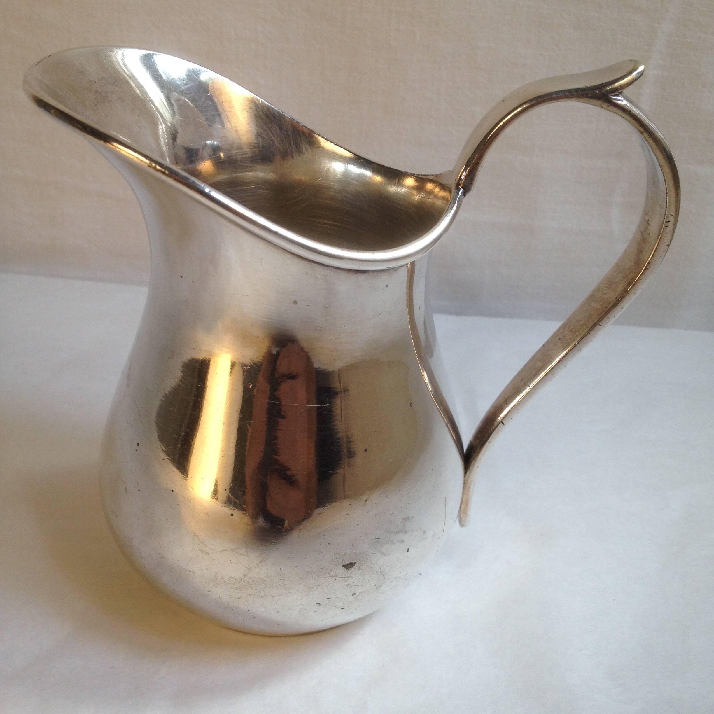 Silver metal milk jug