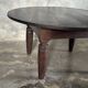 Antique round coffee table in Indonesian teak with turned legs.