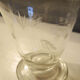Old carafe in engraved glass vegetal decoration