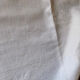 Pair of embroidered white cotton tea towels.
