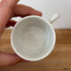 Set of 2 antique earthenware cups with blue floral pattern.