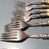 Old silver fish forks with bone handles