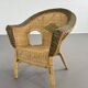 Cabriolet style armchair in rattan, wicker and green and red edging