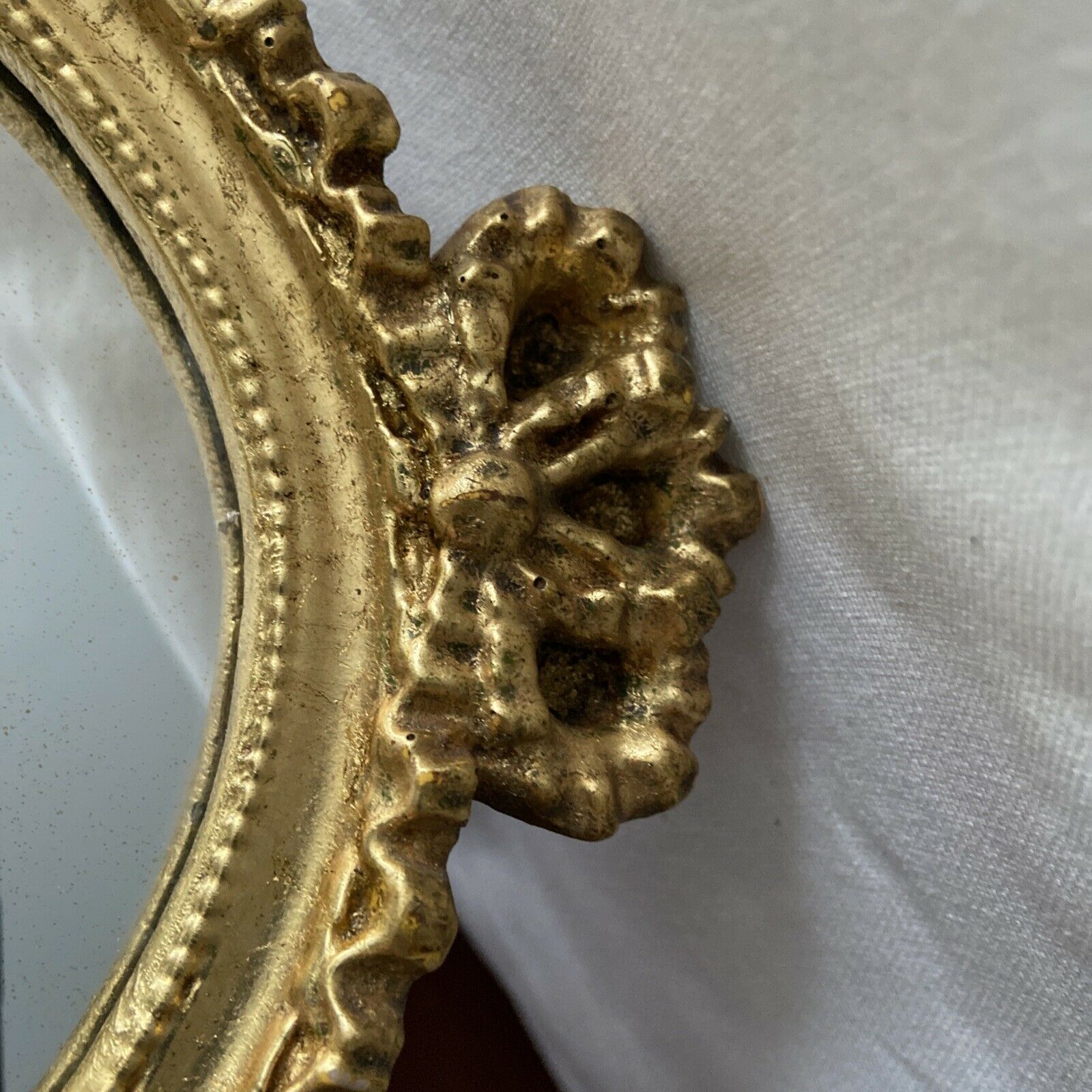 Oval wall mirror in baroque gilded plaster frame 29x20cm