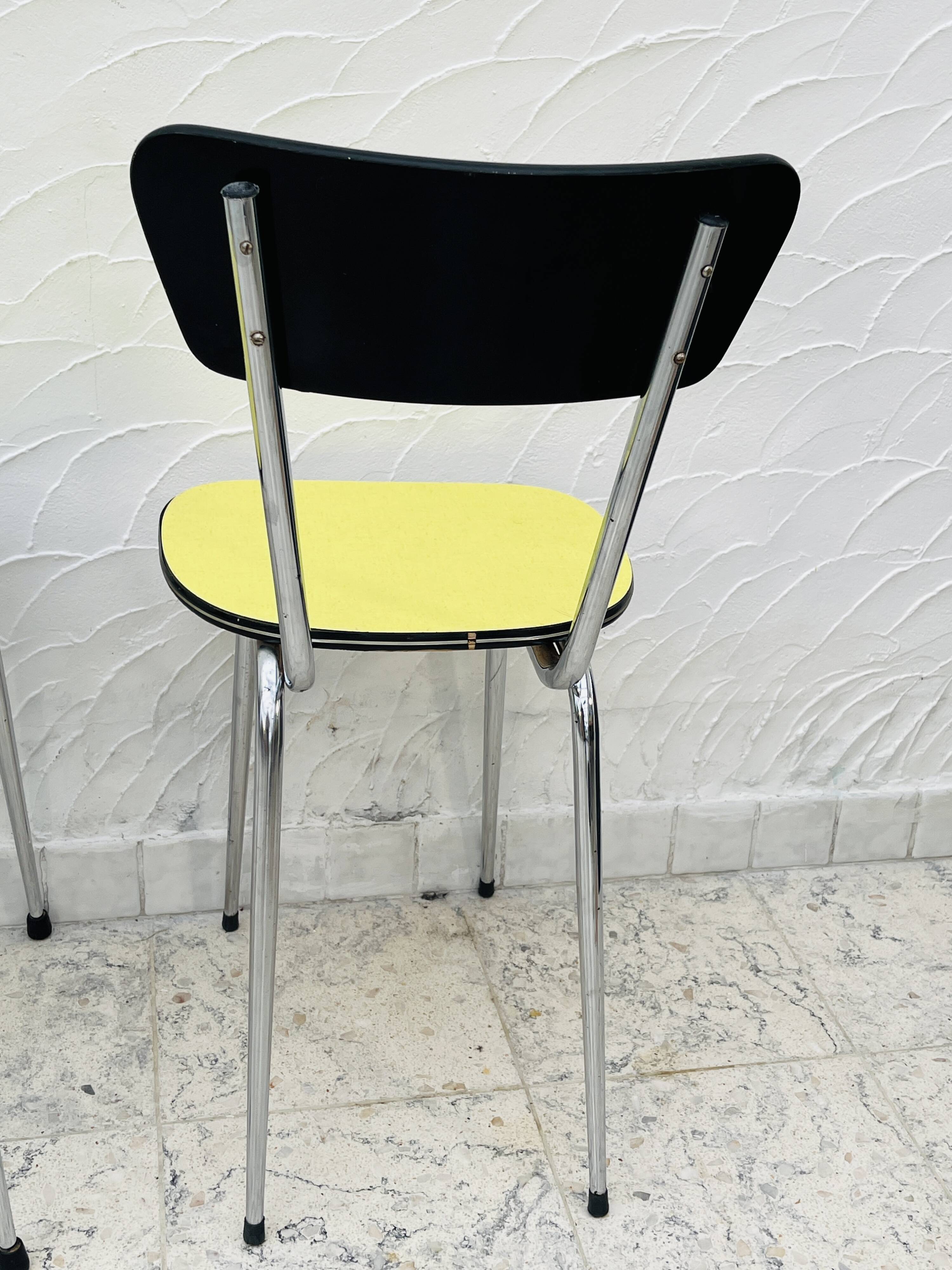 Pair of vintage yellow chrome Formica kitchen chairs.