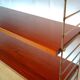 String shelf by Nisse Strinning with three mahogany shelves. Gungrey metal sides.