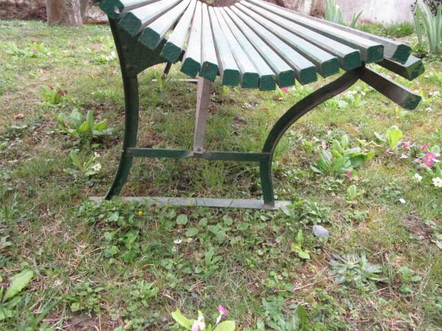 Old metal garden bench with wooden slats
