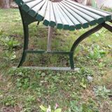 Old metal garden bench with wooden slats