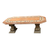 Table composed of a carved stone base with marble and hard stone inlay decoration