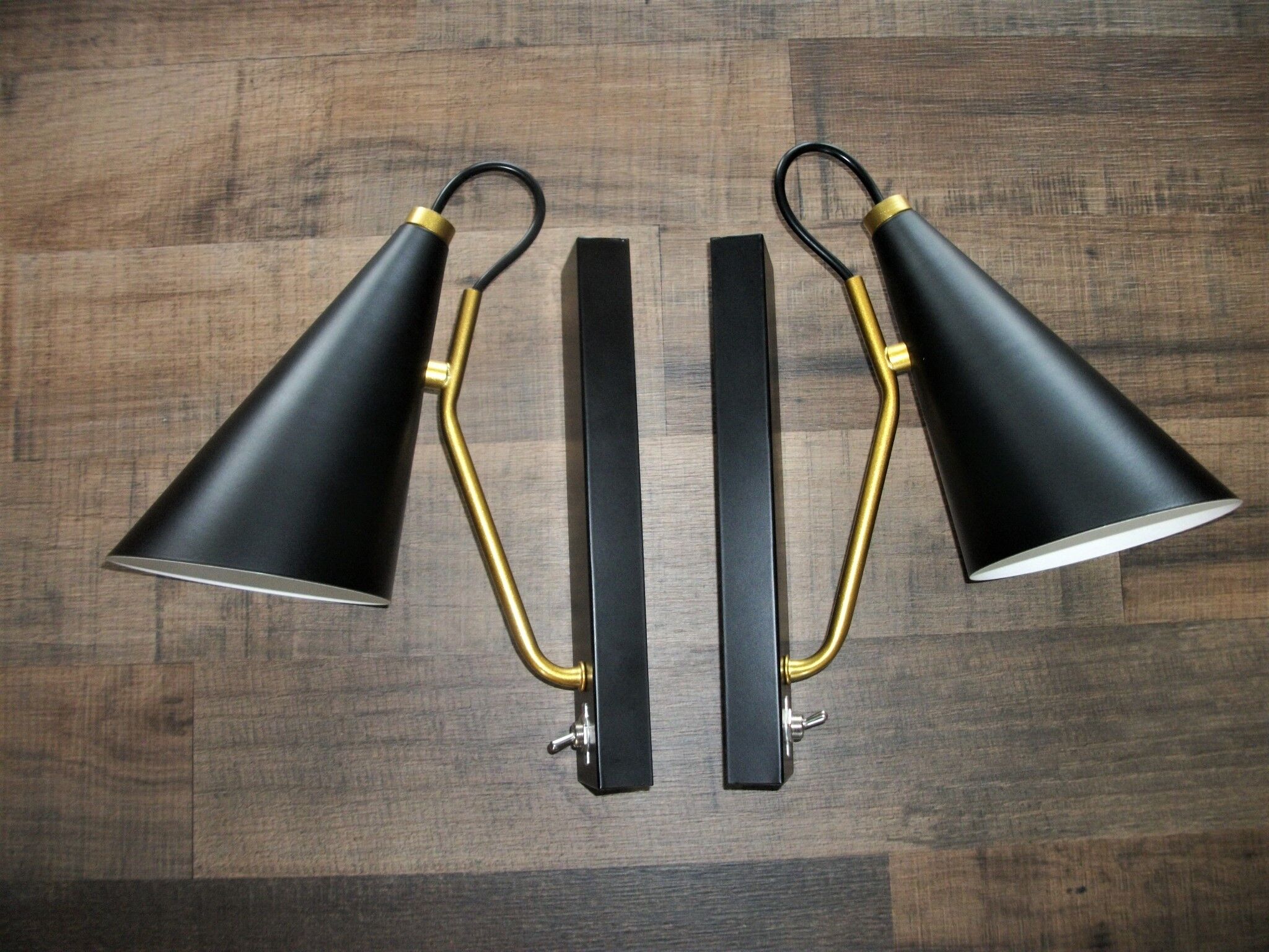 Pair of modernist sconces in black and gold metal